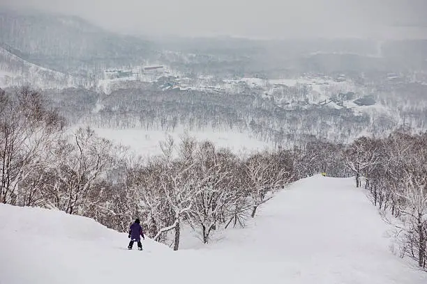 Snowboarder Riding Down the Mountain at Niseko United, Hokkaido, Japan