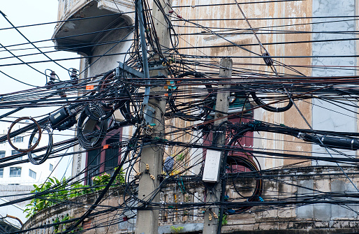 Telephone, electricity pole and wires in Thailand