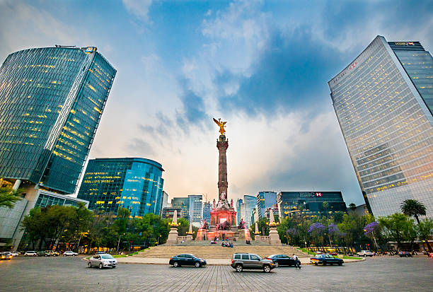 Angel of Independence Mexico City, Mexico - February 27, 2014: The Angel of Independence sitting in the middle of a busy street in Mexico City, Mexico mexico street scene stock pictures, royalty-free photos & images