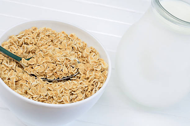 istock Oats in white bowl and pitcher with milk 547208600
