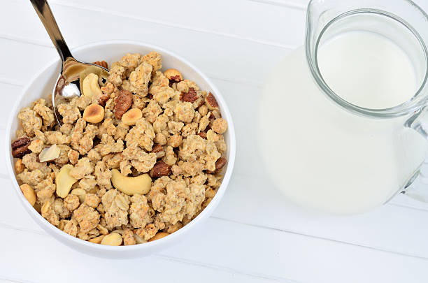 istock Muesli in ceramic bowl and pitcher with milk 547208726