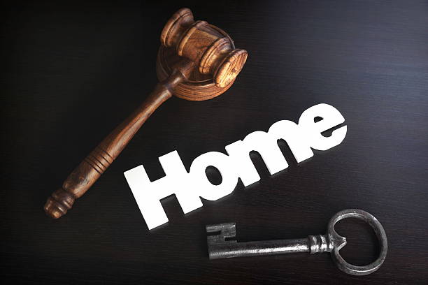 istock Judges Hammer or Gavel With Home Sign On Dark Background 547210670