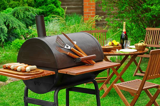 istock Summer Weekend BBQ Scene With Charcoal Grill On The Backyard 547210752