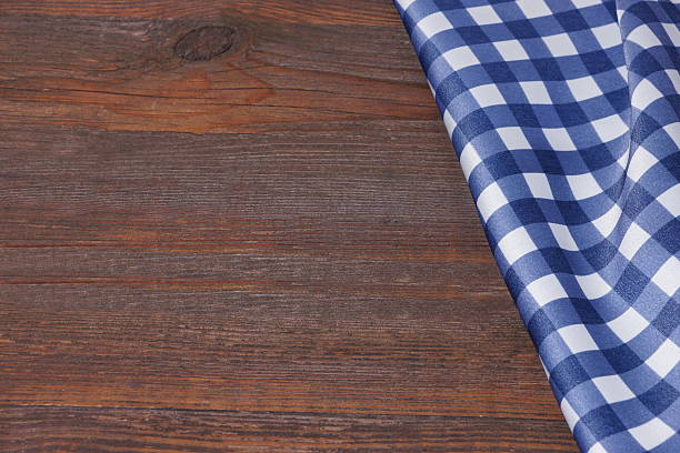 istock Blue Checkered Tablecloth On The Rough Rustic Wooden Table, Over 547210884
