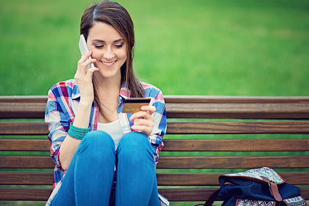 istock Young girl is talking using her mobile phone 547210998