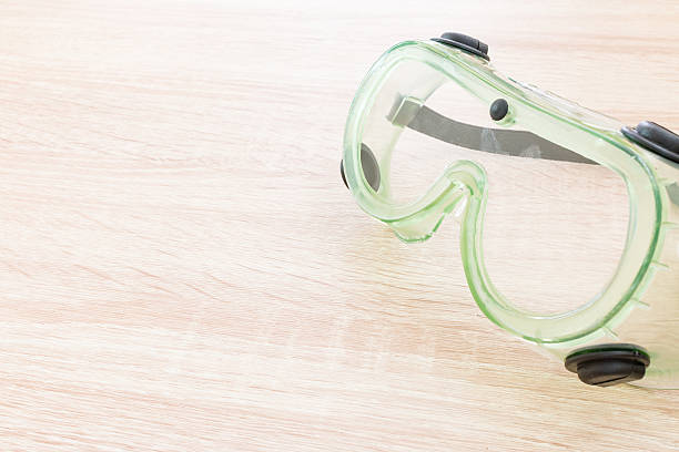 istock Safety glasses on wooden background 547211368