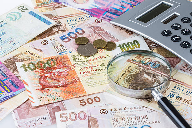 istock Stack of Hong Kong Dollar or banknotes with magnifying glass 547211444