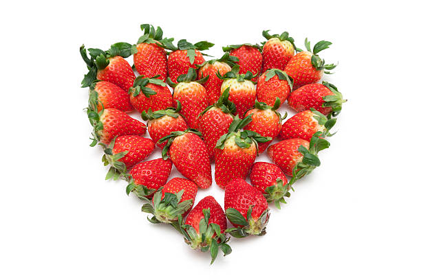 istock Fresh strawberries in heart shape white background isolated 547211974