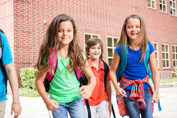istock Back to School:  Elementary-age children, friends on school campus. 547212578