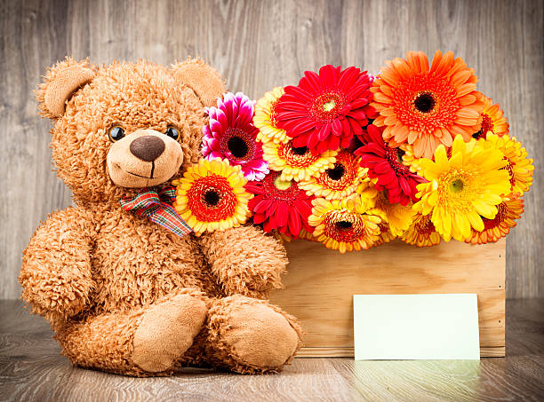 istock Bunch of flowers and a teddy bear 547212948