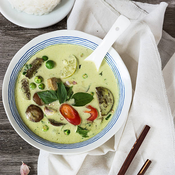 istock Green curry in the bowl on the grey wooden table. 547213304
