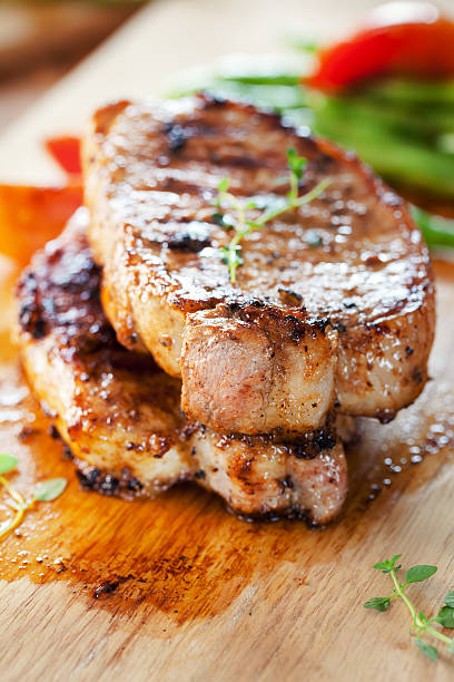 istock pork chops with vegetable on wooden board 547214536
