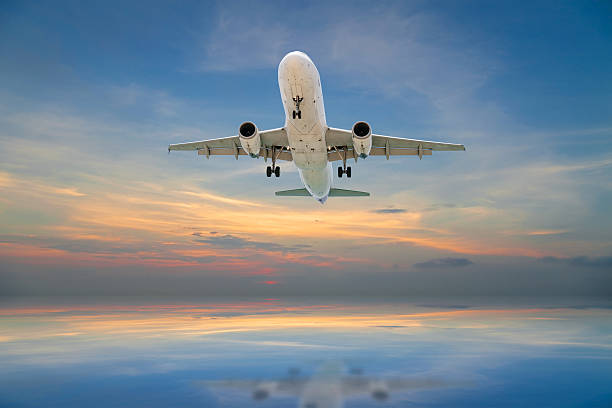 istock Airplane flying tropical sea at sunset time. 547216398