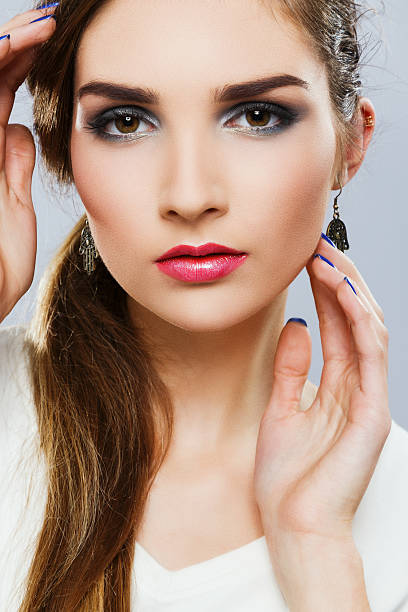 istock Gorgeous girl with colorful make up at gray studio background 547217706