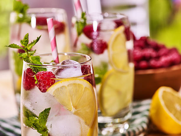 istock On wooden boards is glasses with raspberry mohito and lime. 547218114