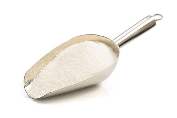 istock granulated sugar in scoop on white 547219944