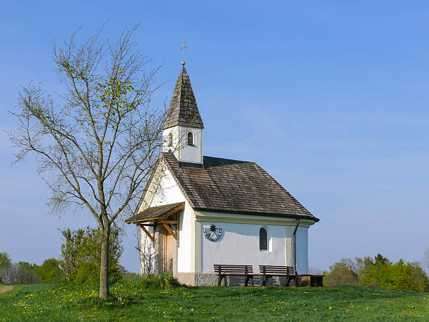 istock Small stone chapel in a Springtime meadow field 547220382
