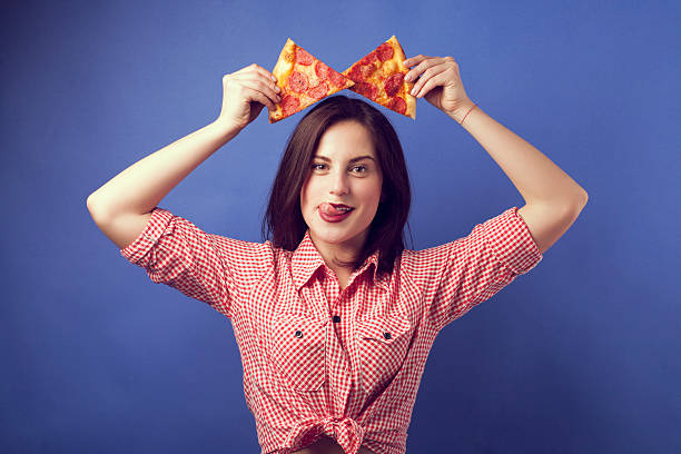 istock Crazy girl with two slides of pizza 547220706