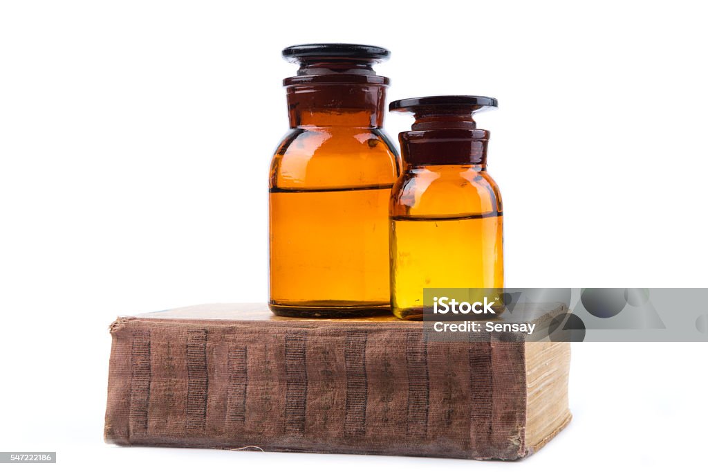 Vintage medicine pharmacy bottles with book Vintage medicine pharmacy bottles with book on white background Antique Stock Photo