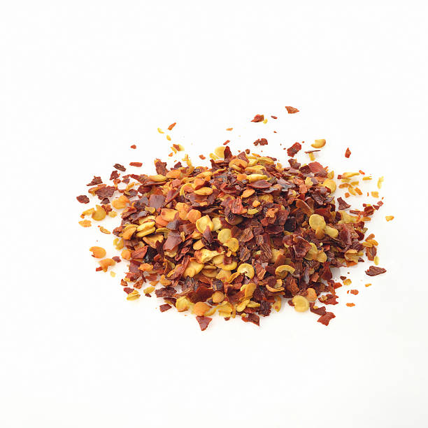istock Red Chili Flakes on White Background 547222356