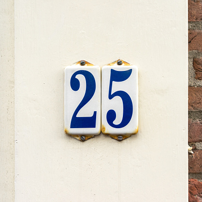 Enameled house number twenty five.