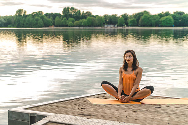 istock beautiful woman sitting in lotus pose 547232068