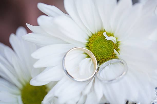 istock Wedding rings on white flower 547232426