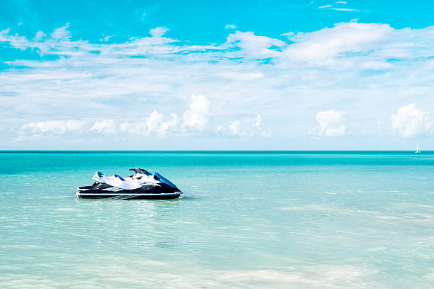 Jet Ski Moored in the Caribbean Sea ot amazing blue background, summer style beach