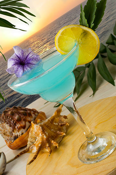 istock Blue cocktail on the tropical sea sunset background 547234514