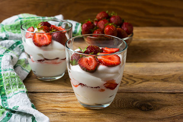 istock Layered strawberries dessert with cream cheese on rustic wooden 547235114