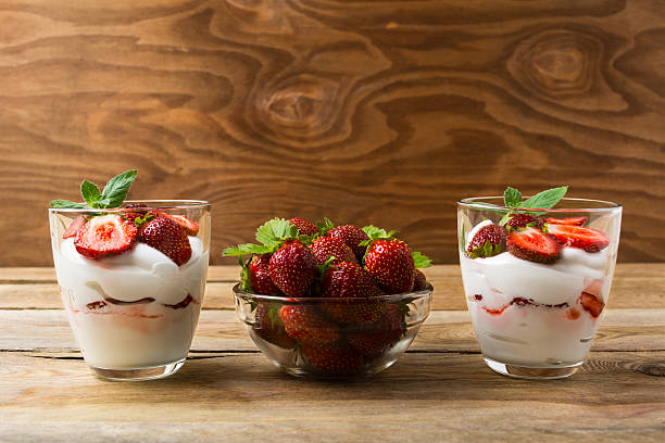 istock Strawberries dessert with whipped cream on rustic wooden backgro 547235196