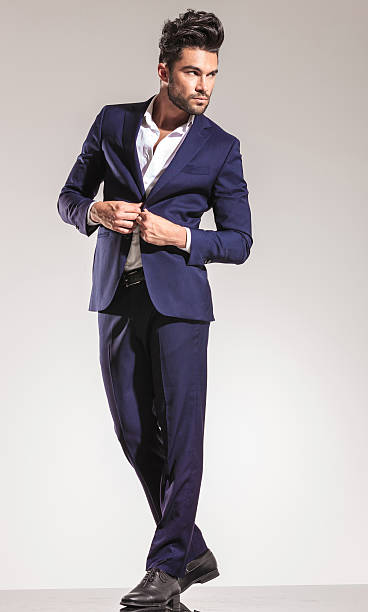 istock handsome young business man closing his coat 547236170