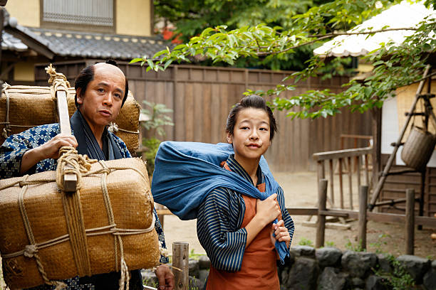 istock Father and son in Edo period carrying luggage 547236370