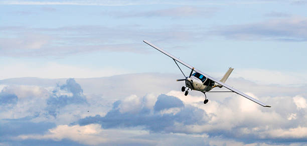 Propeller plane flying Propeller plane flying on the cloudy sky background propeller airplane stock pictures, royalty-free photos & images