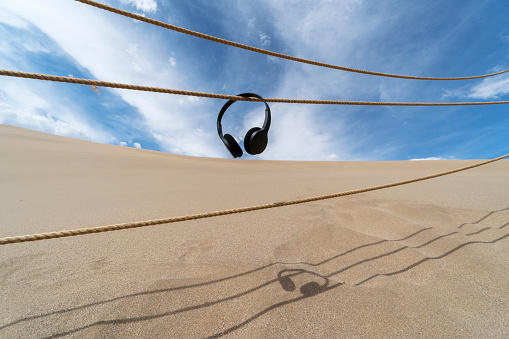 earphone hanging on railing on desert