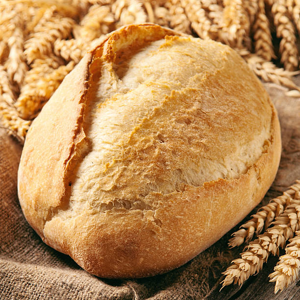 istock loaf of bread with ears of wheat 547238968