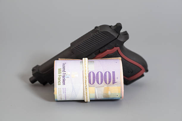 istock Swiss thousand francs in a roll and gun 547239760