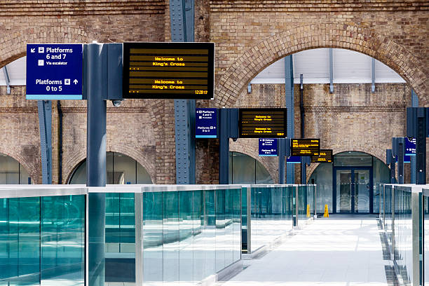 Digital Timetables at Kings Cross Station Digital timetables and platform signs at Kings Cross Station, London, UK london england rush hour underground train stock pictures, royalty-free photos & images