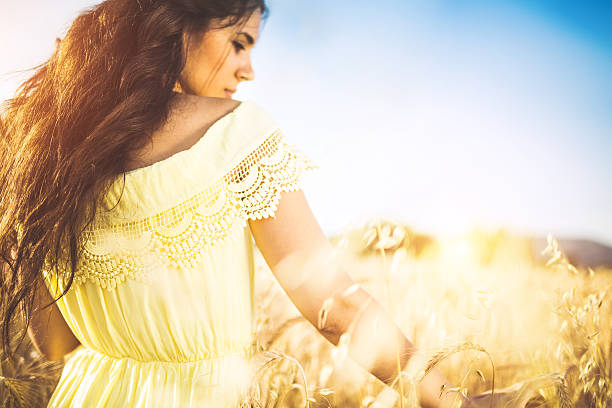 istock young woman at wheat field 547241348