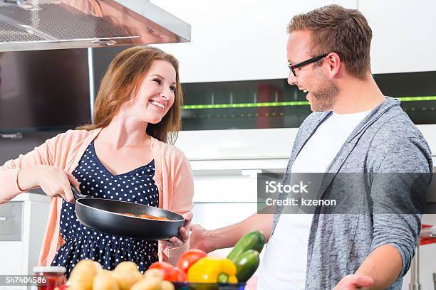 Couple Cooking Pasta In Domestic Kitchen Stock Photo - Download Image Now - Adult, Apartment, Beautiful People