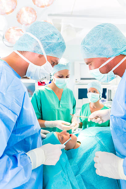 istock Surgeons operating in operation theater room 547404944