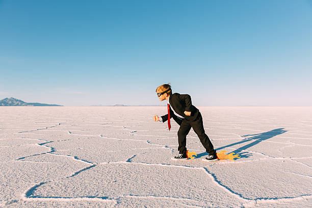 istock Young Businessman Speeds with Fire through Desert 547405520