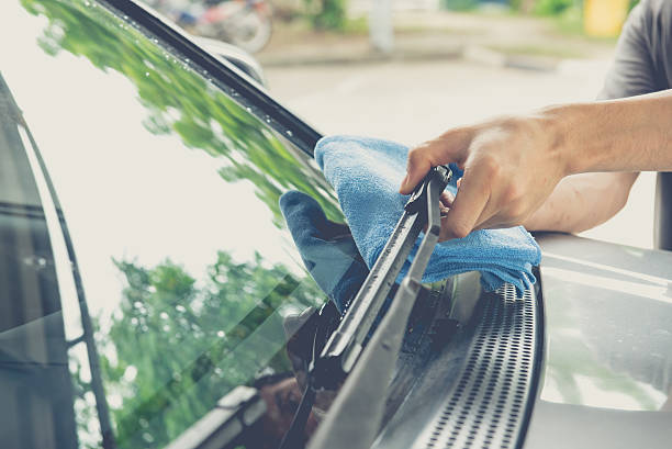 istock Hand wipe the windscreen wiper with cloth 547405616
