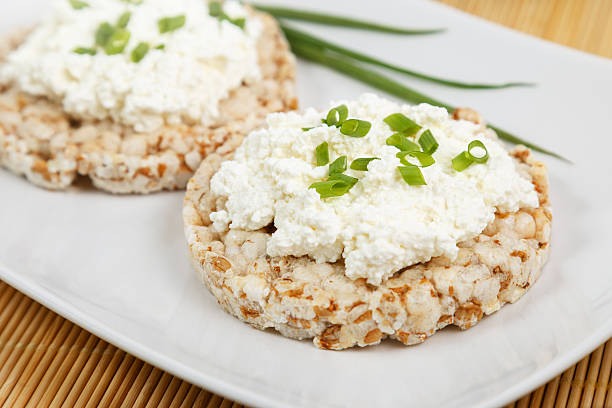 crisp breads with cottage cheese and onion choppes in rings stock photo