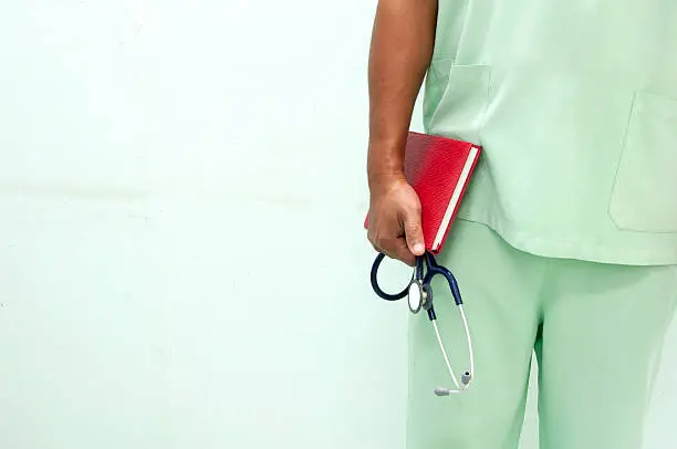 Nurse holding a red book