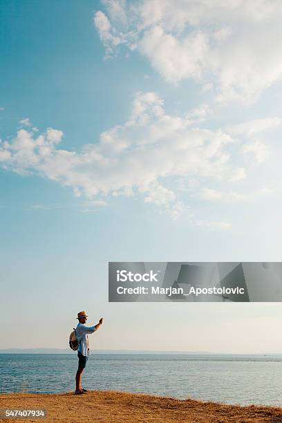 Hiking Man Using Smart Phone Taking Photo Stock Photo - Download Image Now - Coastline, Hiking, Men