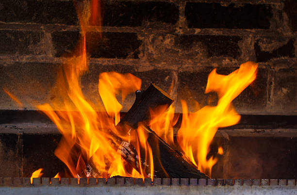 close up of burning fireplace at home heating, warmth, fire and cosiness concept - close up of burning fireplace at home Aflame stock pictures, royalty-free photos & images