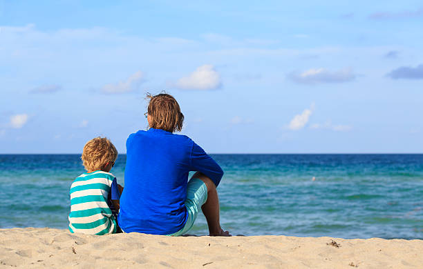 istock father and little son talking on beach 547410216