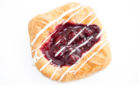 Closeup of a Cherry Danish isolated on white background.
