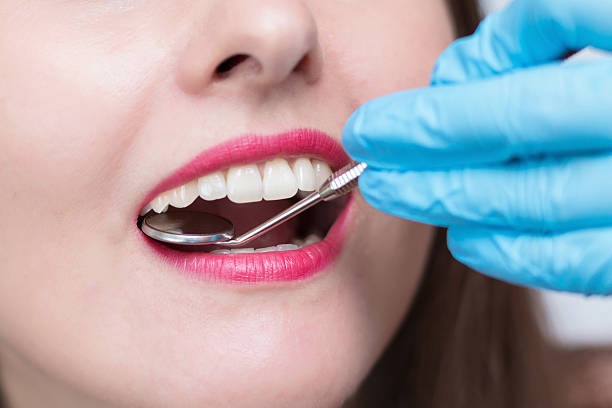 istock Stomatologist examining a young lady's teeth 547411444